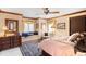 Comfortable bedroom with a window seat, dual windows with sheer curtains, and an area rug at 4181 S Colorado Blvd, Cherry Hills Village, CO 80113