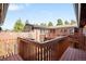 Elevated wood deck offers scenic views of the brick home and surrounding lush greenery, ideal for relaxing at 4181 S Colorado Blvd, Cherry Hills Village, CO 80113