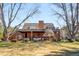 Charming brick home features a covered patio, lush lawn, mature trees, and a serene, park-like setting at 4181 S Colorado Blvd, Cherry Hills Village, CO 80113