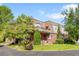 Well-maintained brick home with lush landscaping, a charming balcony, and a circular driveway with ample parking at 4181 S Colorado Blvd, Cherry Hills Village, CO 80113