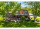 Beautiful home with a brick facade, manicured lawn, and inviting outdoor patio at 4181 S Colorado Blvd, Cherry Hills Village, CO 80113