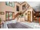 Grand foyer featuring a staircase, chandelier, stone floors, and stained glass window at 4181 S Colorado Blvd, Cherry Hills Village, CO 80113