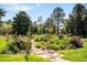 Lush garden featuring stone pathway, an iron trellis with climbing roses, and colorful flowers that provides a tranquil escape at 4181 S Colorado Blvd, Cherry Hills Village, CO 80113