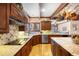 Gourmet kitchen showcasing wood cabinets, modern appliances, and detailed backsplash at 4181 S Colorado Blvd, Cherry Hills Village, CO 80113