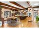 Well-equipped kitchen with wood beams, an island, and a connecting dining area at 4181 S Colorado Blvd, Cherry Hills Village, CO 80113