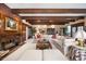 Cozy living room with fireplace, wooden beams, a large sectional, and tasteful decor at 4181 S Colorado Blvd, Cherry Hills Village, CO 80113