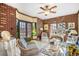 Cozy sunroom with exposed brick, stained glass, comfortable wicker furniture, and natural light at 4181 S Colorado Blvd, Cherry Hills Village, CO 80113