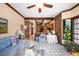 Inviting living area with brick accents, beamed ceilings, and stylish decor at 4181 S Colorado Blvd, Cherry Hills Village, CO 80113