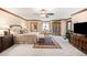 Spacious primary bedroom with a ceiling fan, upholstered furniture, and ample closet space at 4181 S Colorado Blvd, Cherry Hills Village, CO 80113