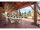 Covered brick patio features a dining area, outdoor kitchen, and serene backyard views at 4181 S Colorado Blvd, Cherry Hills Village, CO 80113