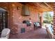 Outdoor kitchen with grill and seating on a brick patio offers a perfect space for entertaining and enjoying the outdoors at 4181 S Colorado Blvd, Cherry Hills Village, CO 80113