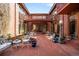 Inviting brick patio with iron furniture, potted plants, and a decorative lamp post at 4181 S Colorado Blvd, Cherry Hills Village, CO 80113