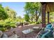 Outdoor patio with lush landscaping, inviting lounge area, and a brick facade at 4181 S Colorado Blvd, Cherry Hills Village, CO 80113