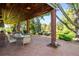 Covered brick patio with outdoor seating and views of the beautifully landscaped yard at 4181 S Colorado Blvd, Cherry Hills Village, CO 80113