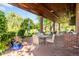 Covered brick patio with comfortable seating, lush landscaping, and serene views at 4181 S Colorado Blvd, Cherry Hills Village, CO 80113