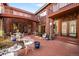 Inviting patio with brick pavers, iron furniture, string lights and charming architectural details at 4181 S Colorado Blvd, Cherry Hills Village, CO 80113