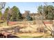 View of the tennis court with a patio area for relaxing in the background at 4181 S Colorado Blvd, Cherry Hills Village, CO 80113