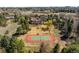 Aerial view of a well-maintained tennis court on a spacious lot surrounded by trees at 4181 S Colorado Blvd, Cherry Hills Village, CO 80113