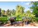 Expansive lawn with flower planters, mature trees, and a tranquil setting at 4181 S Colorado Blvd, Cherry Hills Village, CO 80113