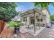 Backyard featuring an outdoor kitchen, a patio, mature trees, and a privacy fence at 19149 E Ida Dr, Aurora, CO 80015