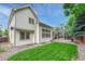 Backyard featuring a well-manicured lawn, privacy fence, mature trees, and a patio area at 19149 E Ida Dr, Aurora, CO 80015