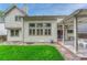 Exterior view of the home showcasing the patio area, back windows, and lush backyard space at 19149 E Ida Dr, Aurora, CO 80015
