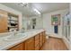 Bathroom featuring double sinks, a large mirror, and a shower/tub combo at 19149 E Ida Dr, Aurora, CO 80015