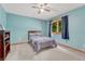 Bedroom with blue walls, neutral carpet, and natural light from the window at 19149 E Ida Dr, Aurora, CO 80015