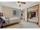 Bright bedroom featuring a ceiling fan, window, and closet space perfect for storage at 19149 E Ida Dr, Aurora, CO 80015