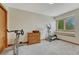 Home exercise room featuring fitness equipment, a window, and neutral carpet at 19149 E Ida Dr, Aurora, CO 80015