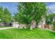 Exterior view showcasing the home's brick accents, mature tree, and manicured lawn at 19149 E Ida Dr, Aurora, CO 80015