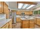 Well-lit kitchen featuring a center island, stainless steel appliances, and light wood cabinetry at 19149 E Ida Dr, Aurora, CO 80015