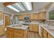 A kitchen featuring a center island, stainless steel appliances, and light wood cabinetry at 19149 E Ida Dr, Aurora, CO 80015