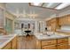 Open kitchen area overlooking living area with fireplace, features wood cabinets at 19149 E Ida Dr, Aurora, CO 80015