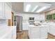 Bright kitchen with white cabinets, stainless steel appliances, hardwood floors, and a center island at 19149 E Ida Dr, Aurora, CO 80015