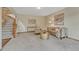 Bright and airy living room with neutral carpet, modern decor, and view of the staircase at 19149 E Ida Dr, Aurora, CO 80015