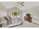 Comfortable main bedroom with a large window, ceiling fan, dresser, and neutral color scheme at 19149 E Ida Dr, Aurora, CO 80015