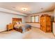 Spacious bedroom with large window, and wooden furniture at 20606 Yoke Trl, Morrison, CO 80465