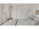 Bright bedroom featuring a sliding closet door, neutral color palette and entry to another room at 3613 S Sheridan Blvd # 11, Denver, CO 80235
