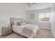 Bright bedroom with large window, neutral decor, and comfortable bed with side tables at 3613 S Sheridan Blvd # 11, Denver, CO 80235