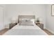 Cozy bedroom with nightstands on either side, neutral headboard, and decorative gray pillows on white bedding at 3613 S Sheridan Blvd # 11, Denver, CO 80235