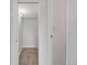 A well-lit walk-in closet with neutral carpeting and access to additional storage space at 3613 S Sheridan Blvd # 11, Denver, CO 80235