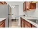 Modern kitchen features stainless steel appliances and a view into the dining area at 3613 S Sheridan Blvd # 11, Denver, CO 80235