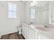 Modern bathroom showcasing double sinks, quartz countertop, and a serene atmosphere at 6554 N Malta St, Aurora, CO 80019