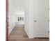 Hallway featuring hardwood floors leading to bright, open living area at 6554 N Malta St, Aurora, CO 80019