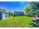 Large backyard with lawn, storage shed, landscaping, and a fire pit, perfect for relaxing and outdoor activities at 9446 W Wagon Trail Cir, Littleton, CO 80123