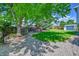 Spacious, fenced back yard featuring a play set, lush lawn, and garden area, ideal for outdoor entertaining at 9446 W Wagon Trail Cir, Littleton, CO 80123