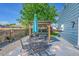 Outdoor patio area with table, chairs, grill, and seating under a pergola at 9446 W Wagon Trail Cir, Littleton, CO 80123