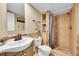 Well-lit bathroom featuring a mosaic tile shower, storage niche, and elegant fixtures at 9446 W Wagon Trail Cir, Littleton, CO 80123