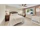 Cozy bedroom featuring neutral tones, ceiling fan, and ample natural light at 9446 W Wagon Trail Cir, Littleton, CO 80123